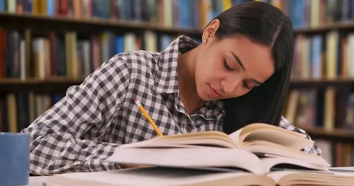 Young person reading in the library