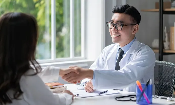 Aperto de mãos entre médico e paciente
